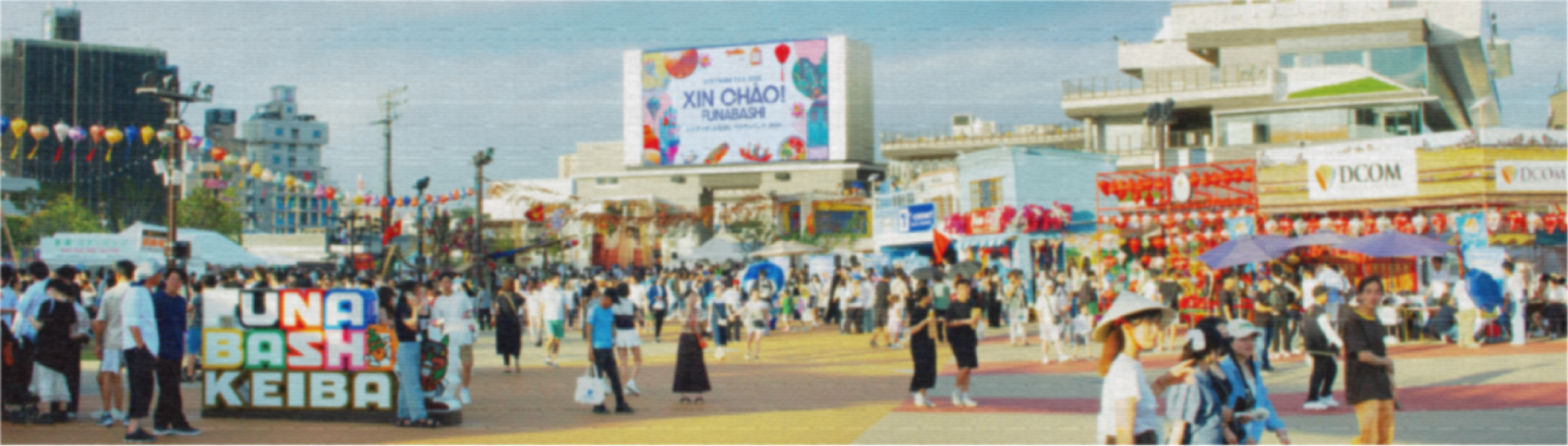 多くの来場者で賑わう船橋競馬場のイベント会場。左側に『FUNABASHI KEIBA』の文字オブジェ、右側に出店ブース、中央奥にはデータを表示した大型スクリーンが見える。